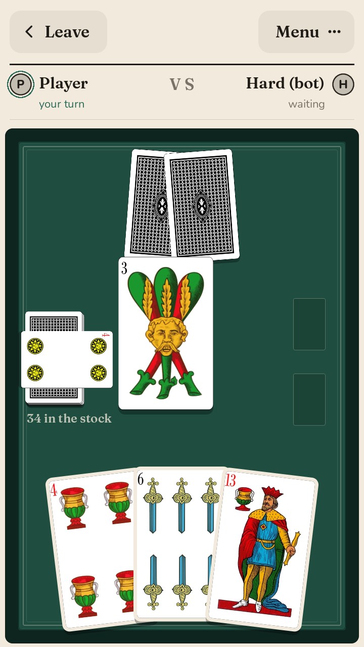 Briscola table with the Neapolitan deck: two cards face down for the opponent, the trump card beside the stock, three cards in hand